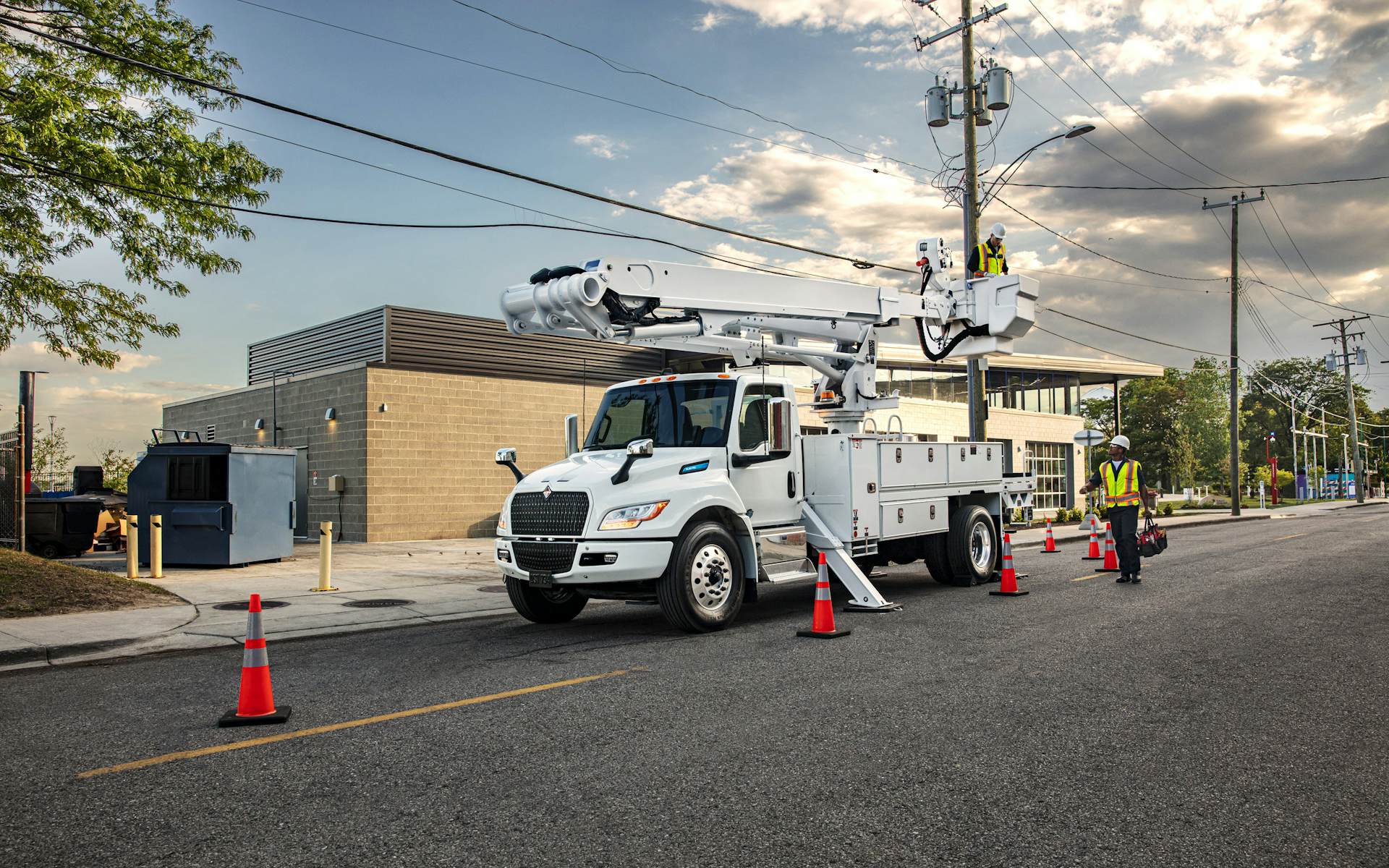 A white truck with a crane on top of it