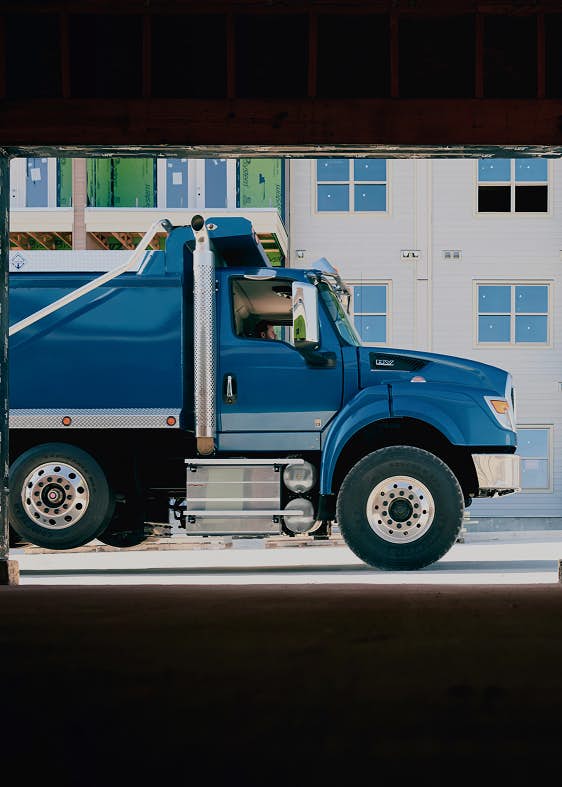 A blue truck in front of a building
