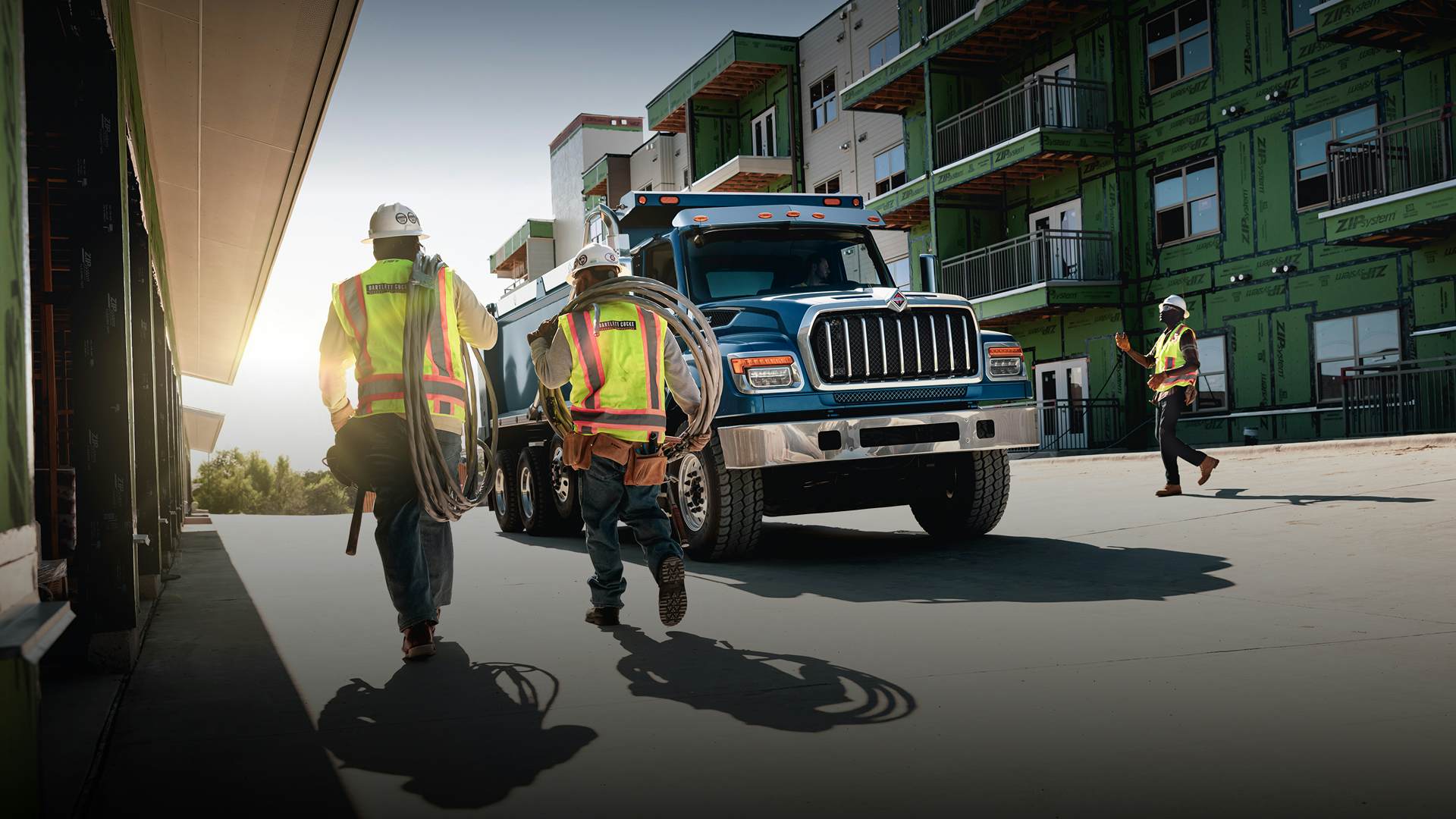 Workers standing in front of a blue truck