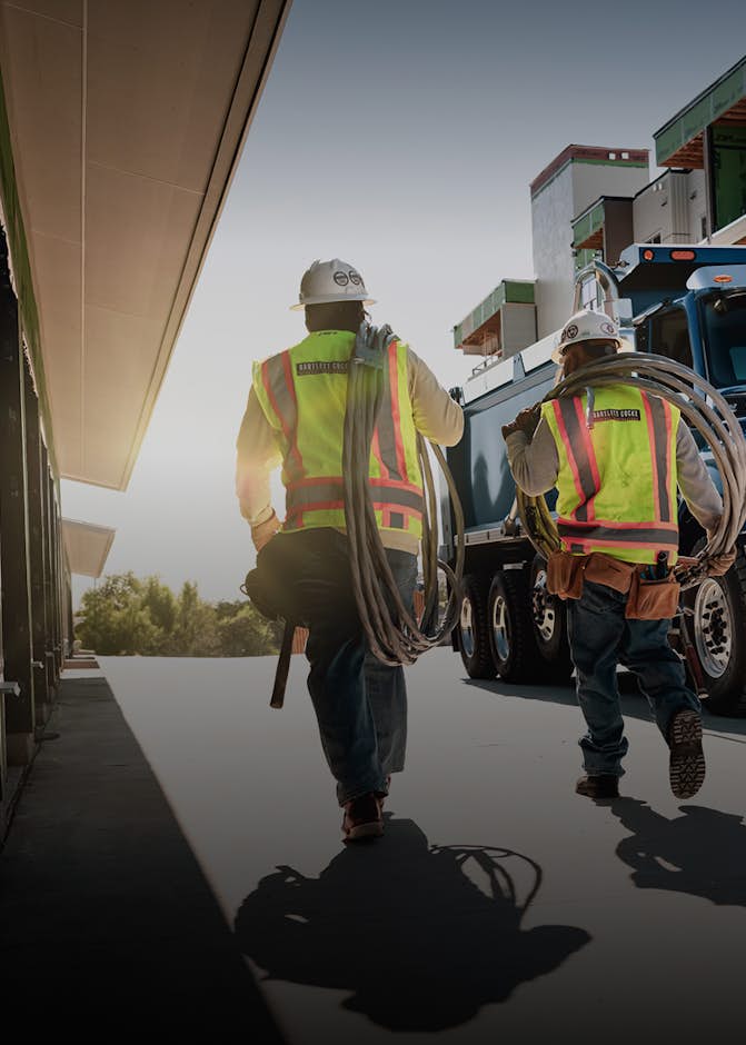 Workers standing in front of a blue truck