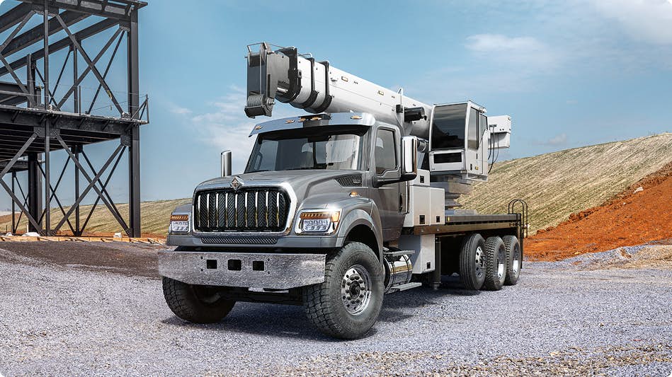 A gray truck on gravel