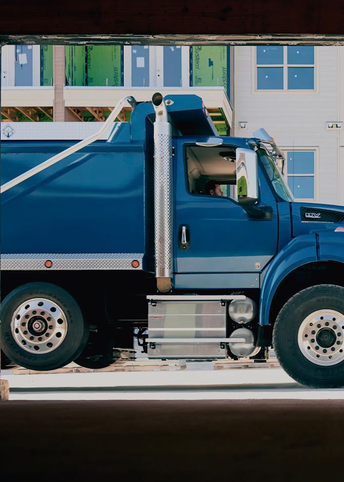 A blue truck in front of a building