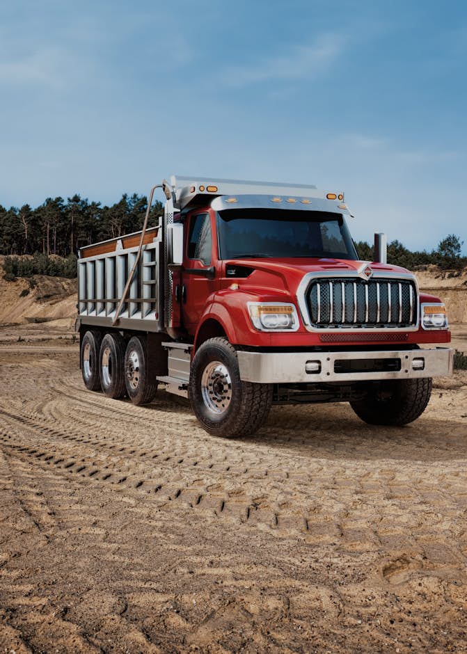 A red truck on a dirt road