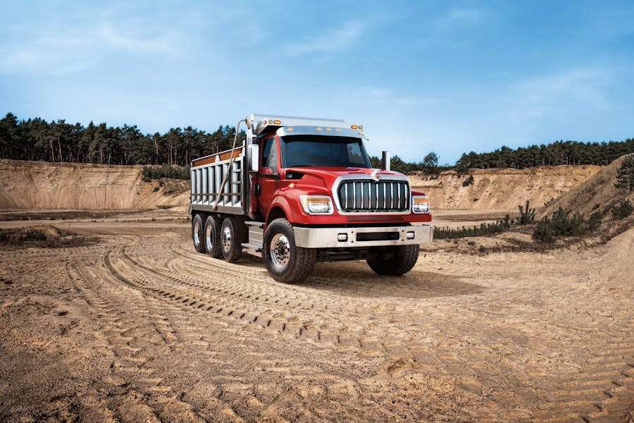 A red truck on a dirt road