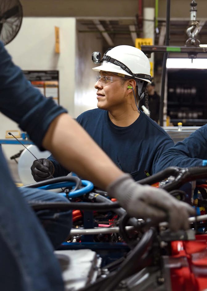A group of people working on a machine